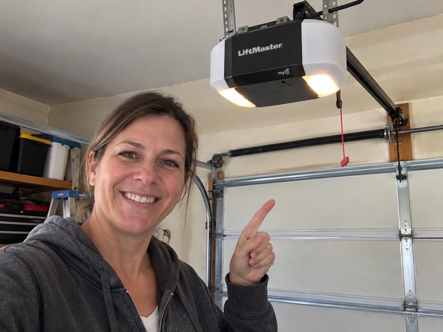 Jennifer M. pointing to her garage door opener following sensor adjustment
