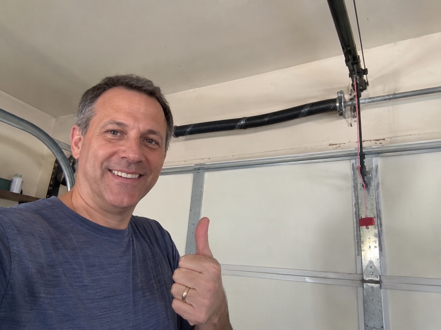 Michael R. beside his garage door following spring repair